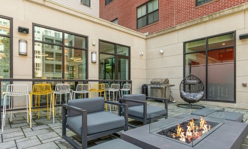 lounge and firepit space at flats at 131 apartments in downtown beverly as part of the beverly collection