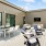 an outside deck area with tables and chairs on it