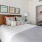 a bed with a red and white pillow